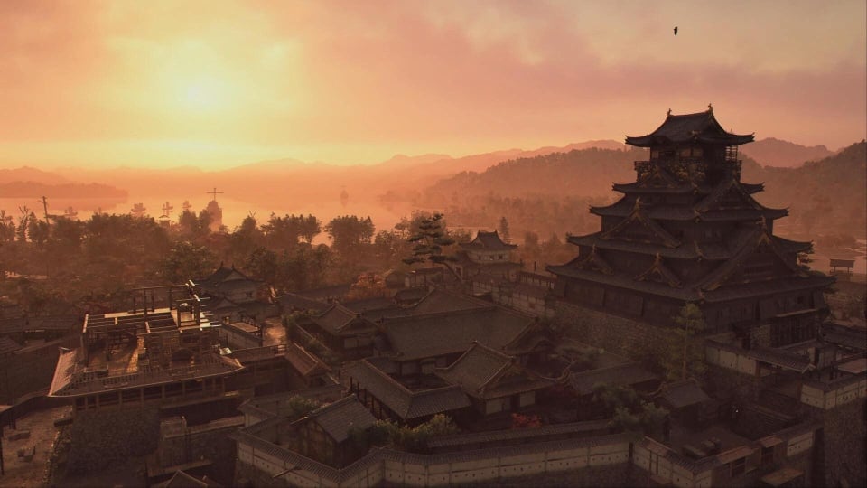 The sun sets over a castle in Assassin's Creed Shadows