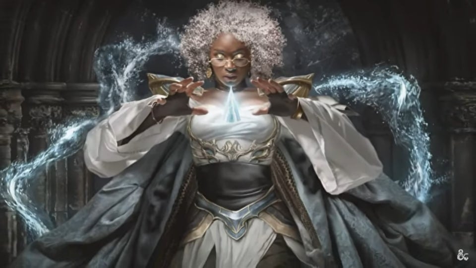 A woman in silver flowing robes with a crystal floating in her hands. The crystal is glowing.
