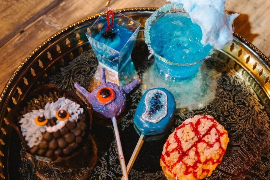 A screenshot showing novelty snacks and drinks on an ornate plate. Candy in the shape of an owlbear, beholder, gelatinous cube, and an intellect devourer.