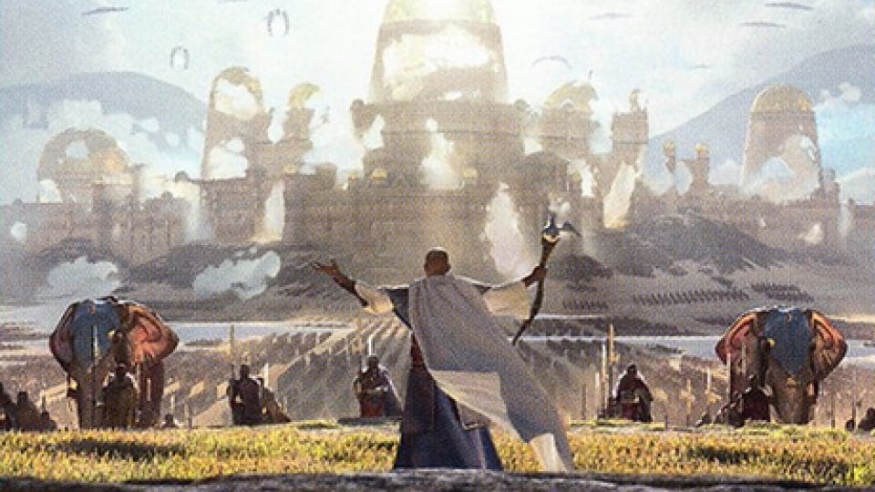 A man in white robes standing with his arms raised in front of an army