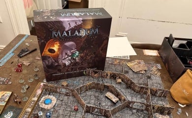 An image from our Maladum Review depicting the board game partially set up on a table