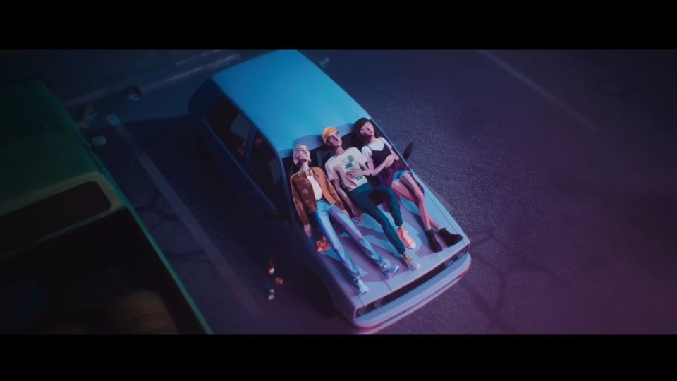 Three teenagers laying on the hood of a car.