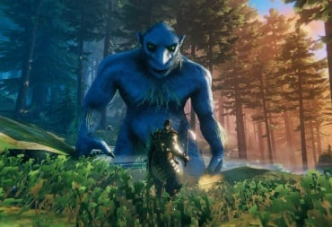 The player looking up at a massive troll in Valheim