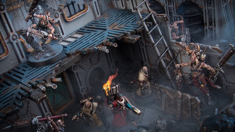 An enclosed bunker with multilimbed monsters and armored men wielding torches.